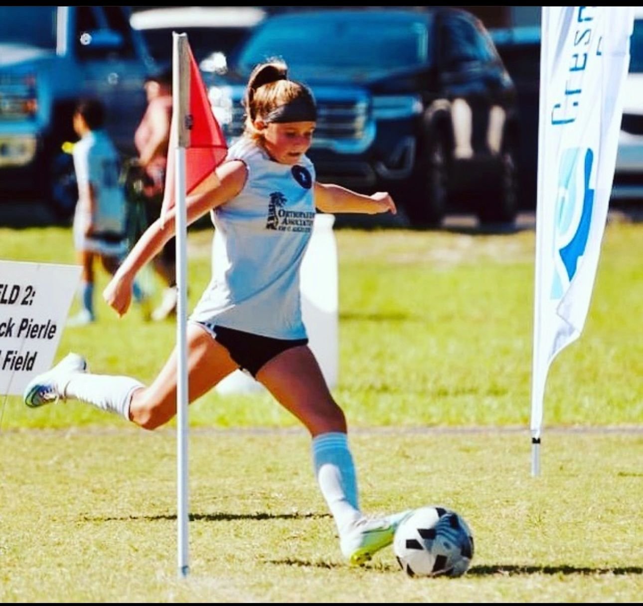 Young player striking a corner kick at full speed