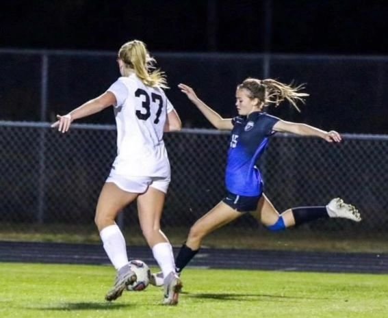 Kiley Capling striking the ball in a night match