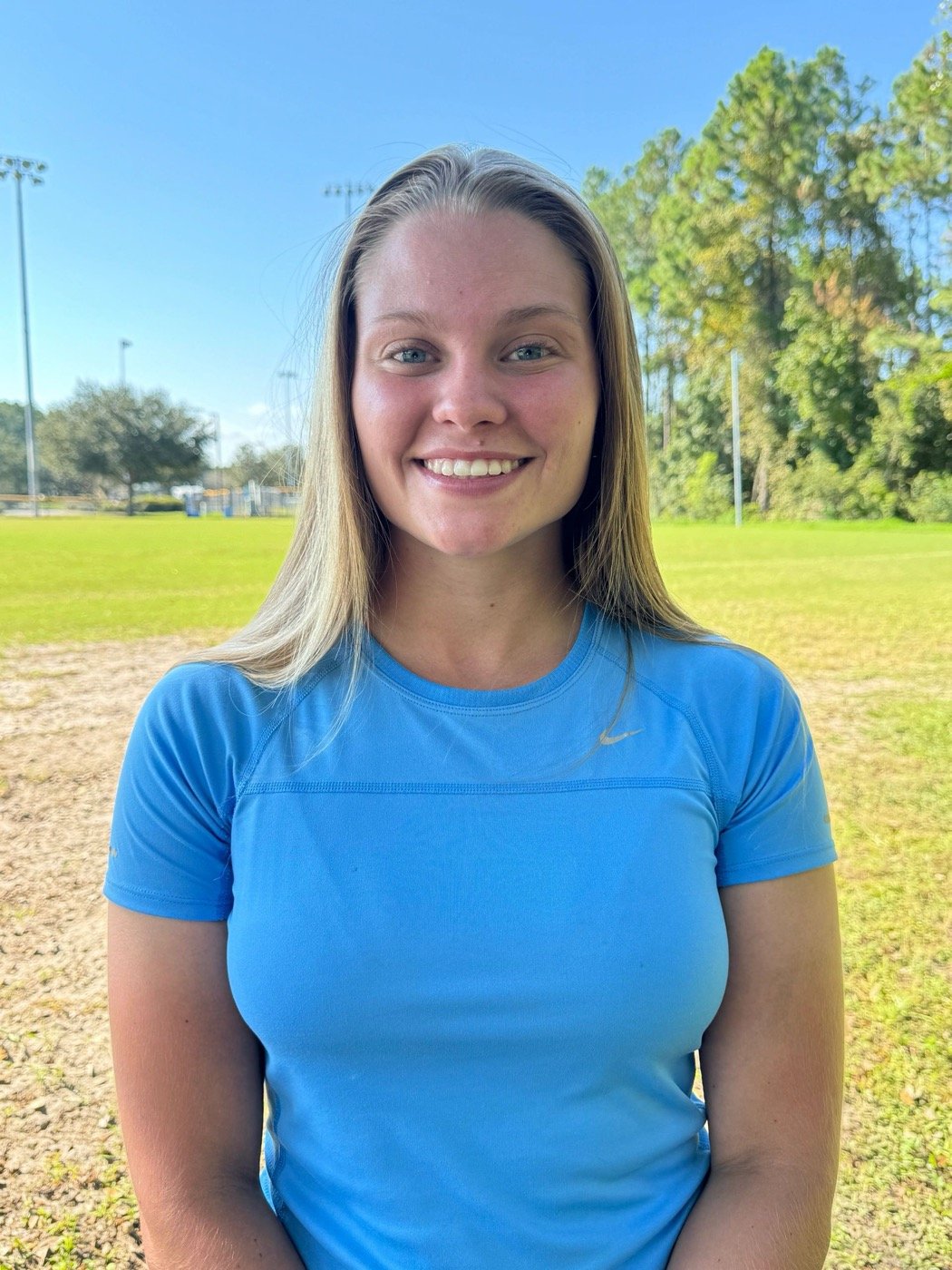 Coach Kiley Capling standing on a soccer field